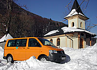 Bob's bus at small chapel in winter